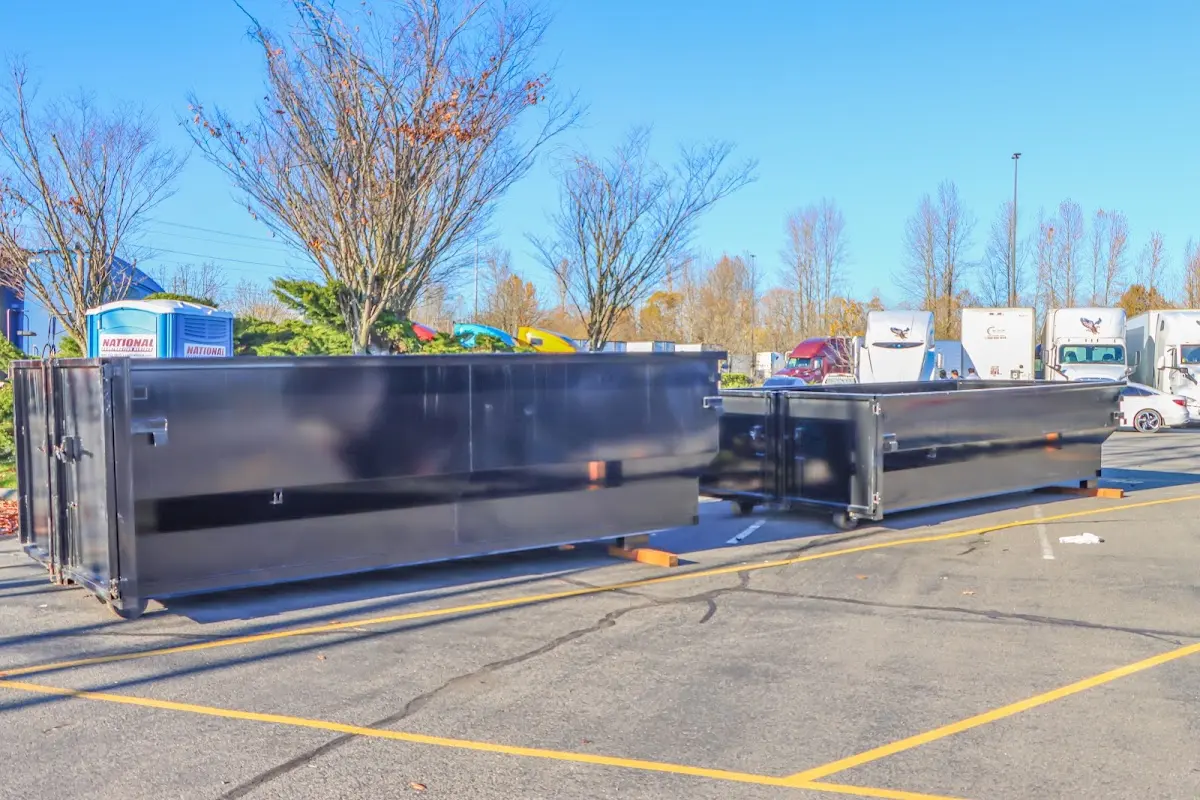 Professional dumpster rental service with roll-off container on residential driveway in Pflugerville